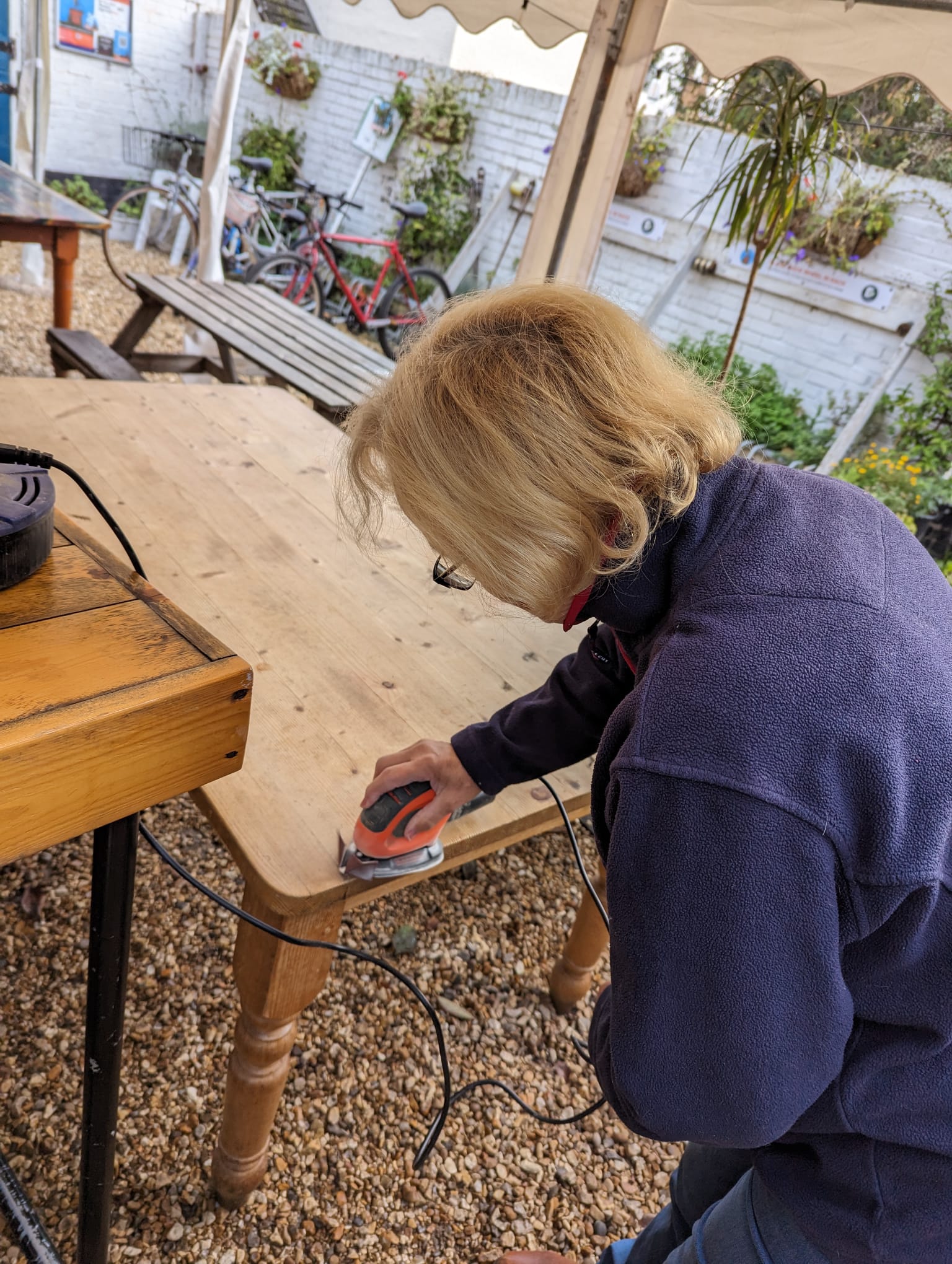 Dawn sanding down one of the tables.