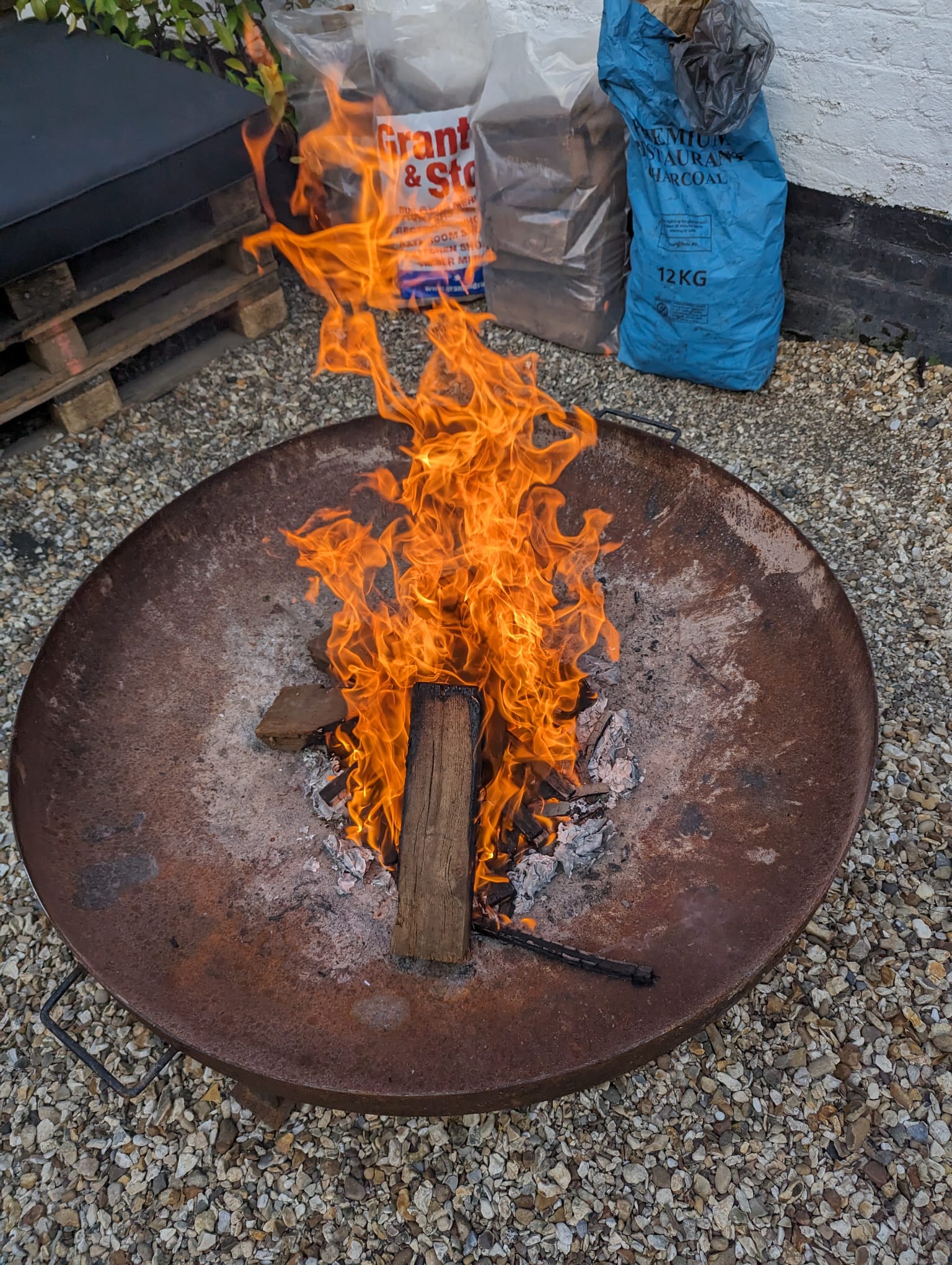 The firepit was lit to keep people warm.