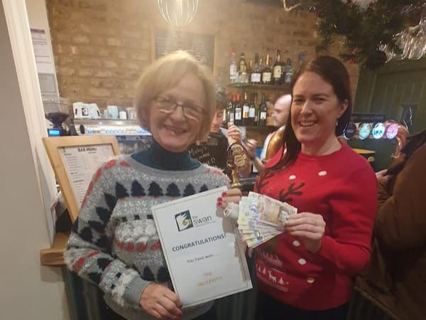 Dawn being presented with the cash certificate by Anne, one of the volunteers.