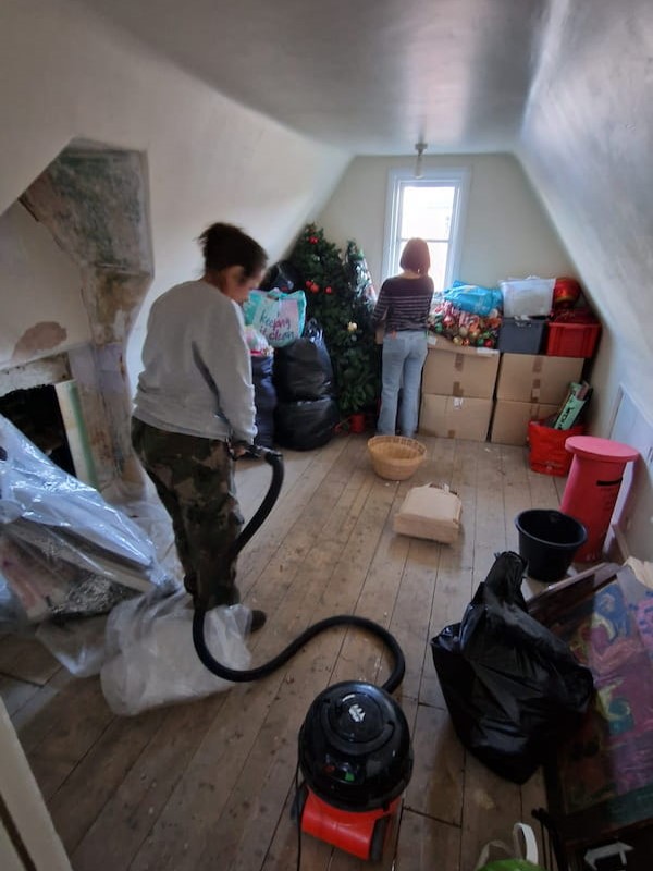Some of the team tidying up a bedroom on the second floor.