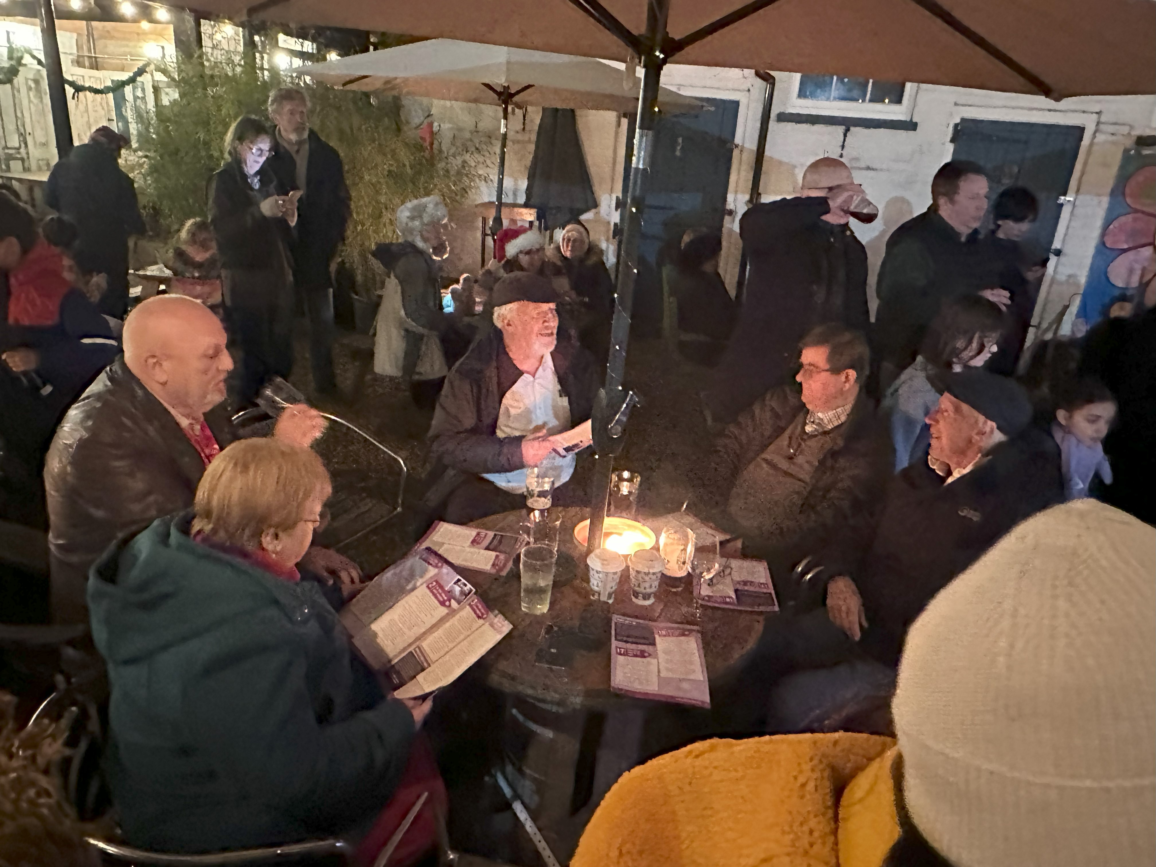 A full table in The Courtyard with carol singers