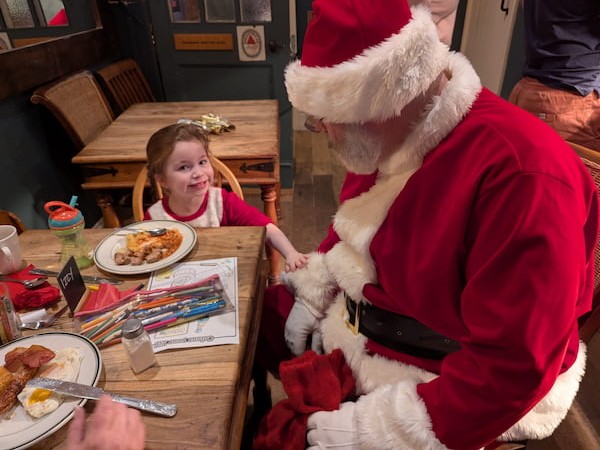 Small girl speaking to Santa