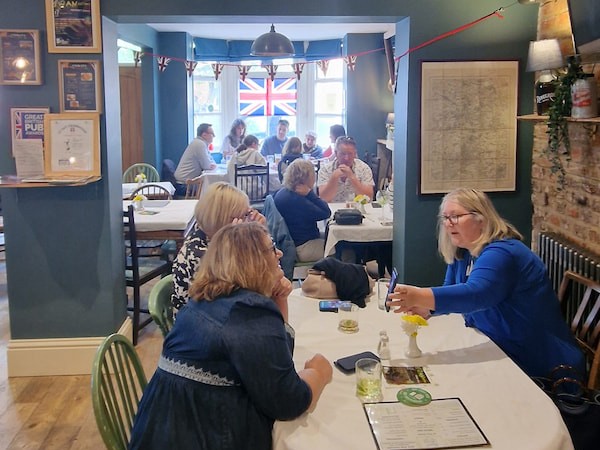 VE Day 80 and a table of ladies having a chat inside the pub