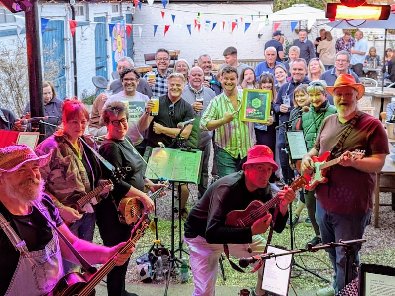 The Windsor Ukulele Band and their audience celebrating with Micky