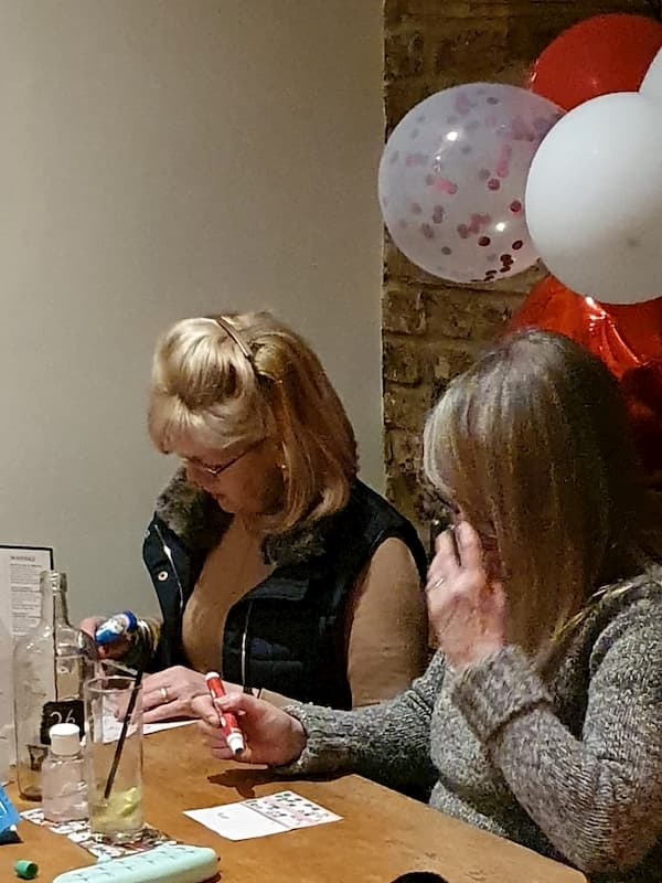 Two laides checking their cards