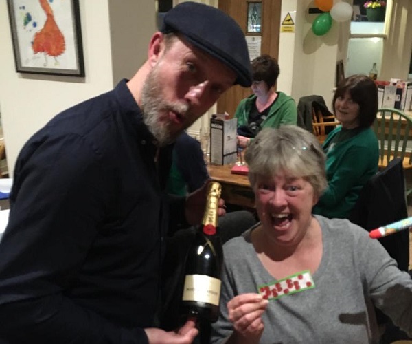 Our flier winner - Trudy - being presented with a bottle of champagne by our bingo caller