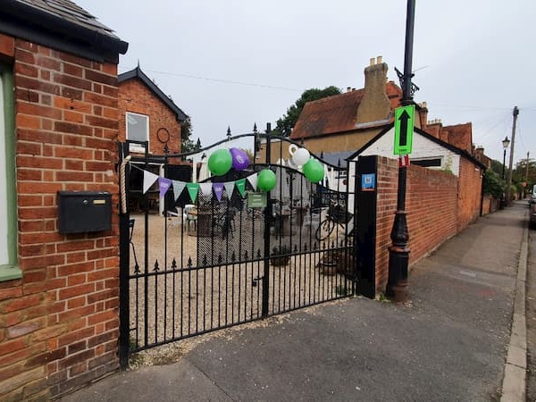 Macmillan balloons and bunting on the main gate
