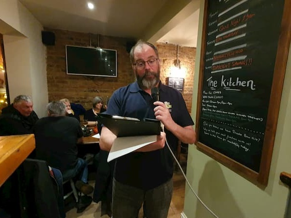 A pensive quizmaster preparing for the next round of brain stimulating questions.