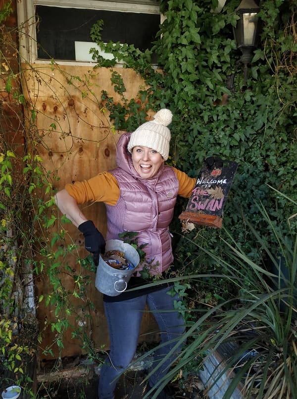 A happy member of the team in front of the boarded up side door