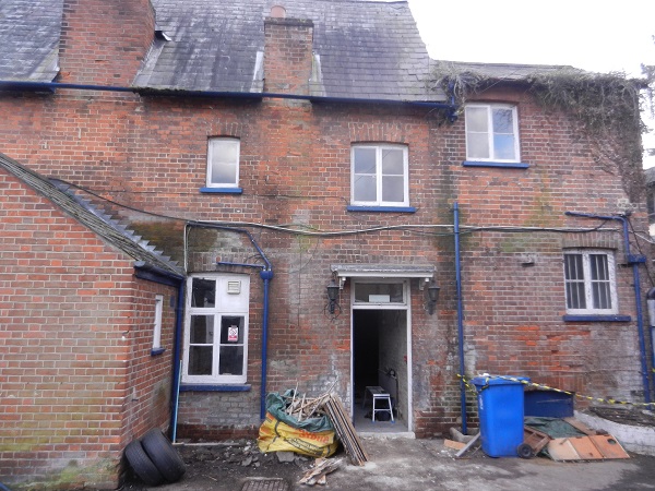 All the ivy, boarding, etc has been removed from the side of the pub