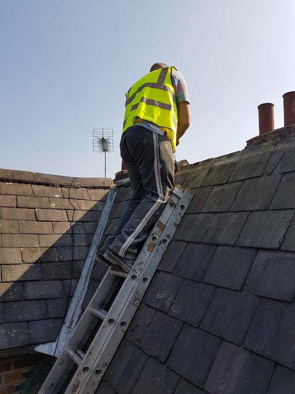 Up on the roof trying to make it more water tight