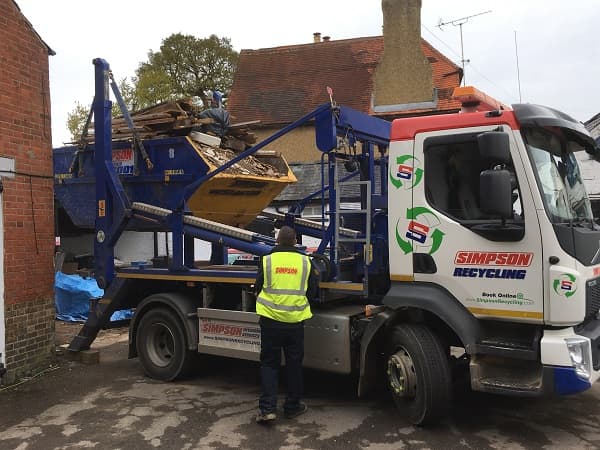 Skip being loaded onto back of the lorry