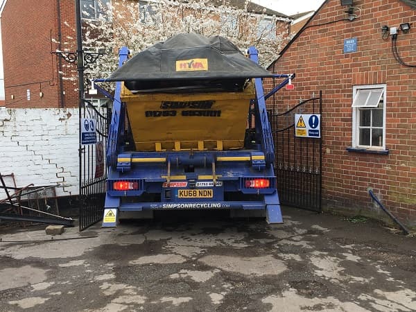 Skip lorry half way through the gates