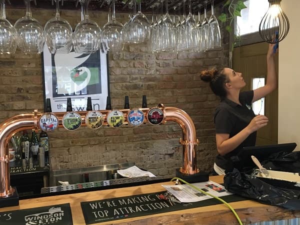 New barmaid helping out painting