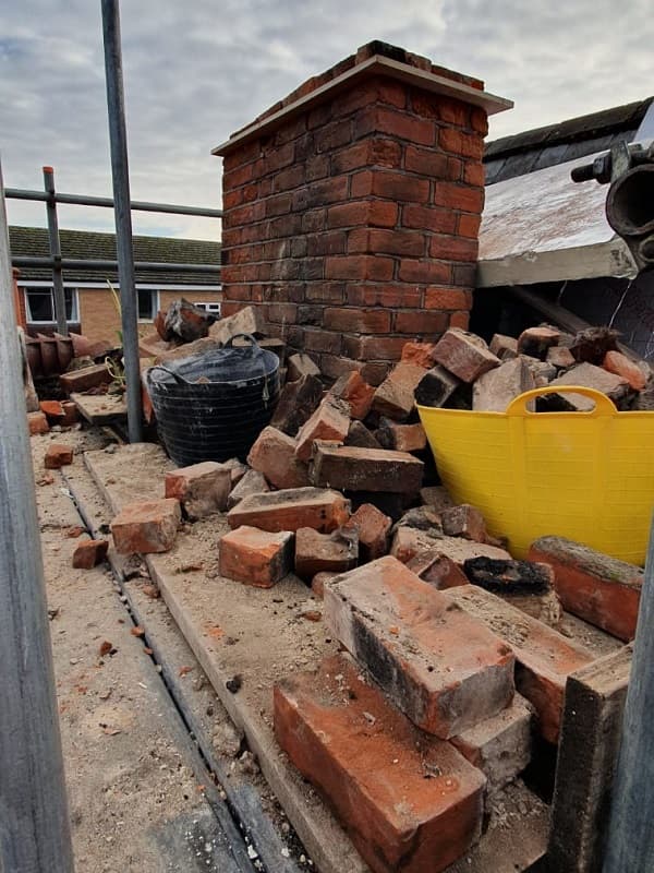 Materials removed scattered around what is left of the chimney