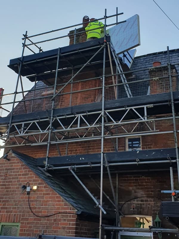 View rom ground level of the team working to reduce the chimney height