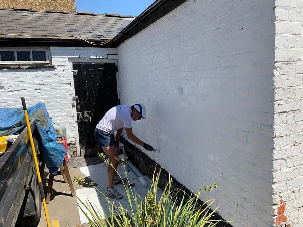 Trevor painting walls of The Stables