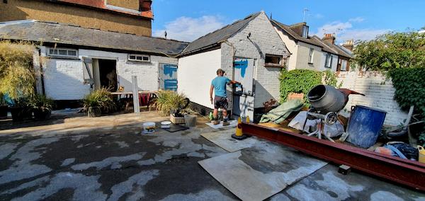 The whole stable was painted white with a footing of black and blue doors