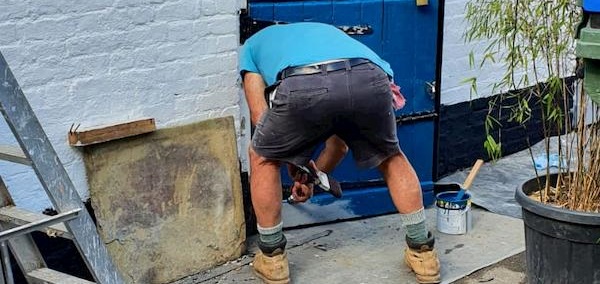 John painting the stable doors