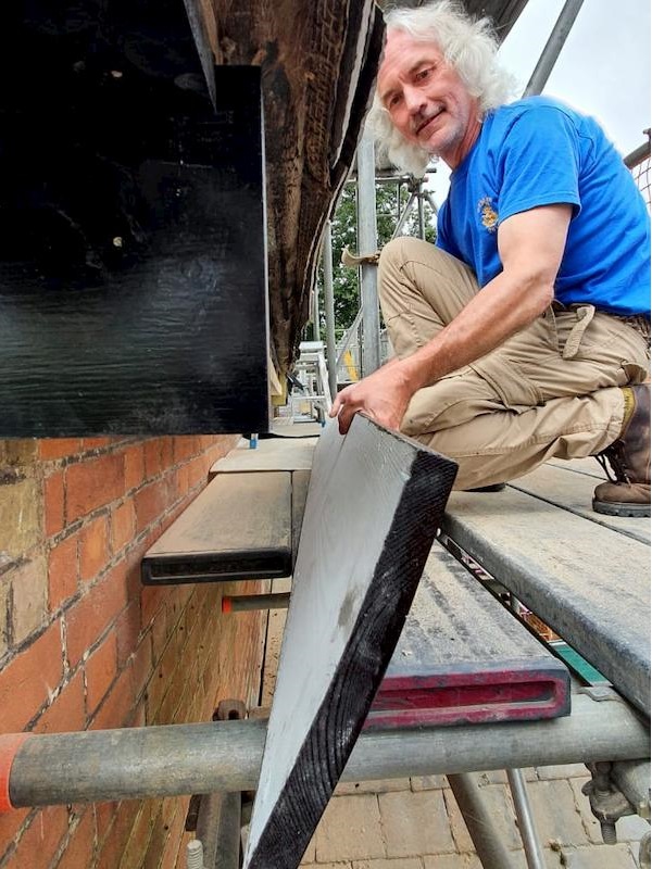 Scraping one of the window frames of the main pub