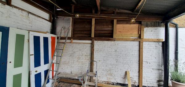 Scraping one of the window frames of the main pub