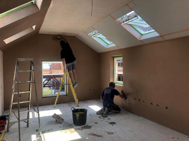 Plasterer hard at work inside The Coach House