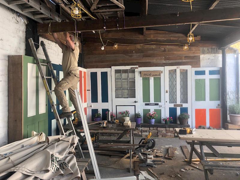 Scraping one of the window frames of the main pub