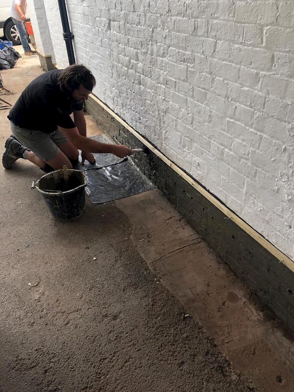 Painting the lower part black after it had been prepared.