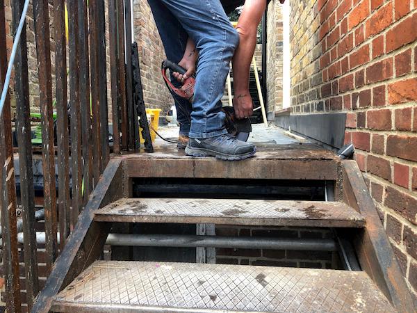 Safety tiles at the top of the wrought oiron stairs laid for safety