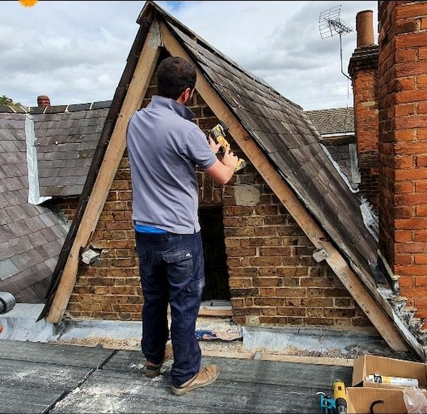 Working on the apex of the roof