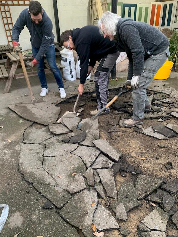 Lads breaking up the tar on the surface of The Courtyard