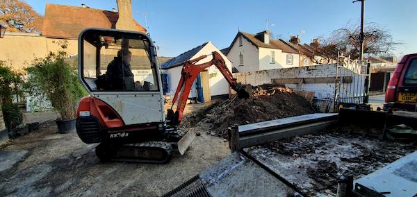 The digger carving through the base of The Courtyard