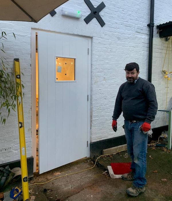 The door is on The side of The Coach House