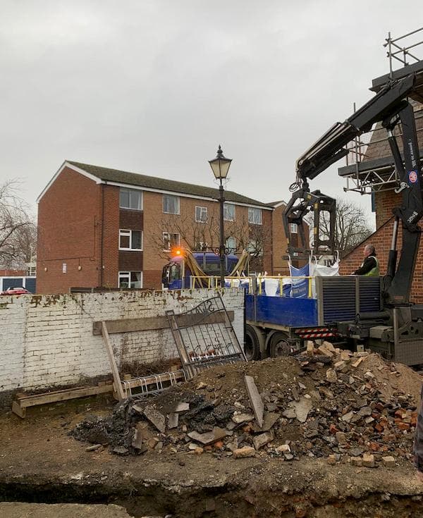 Unloading bags of material using crane attachement