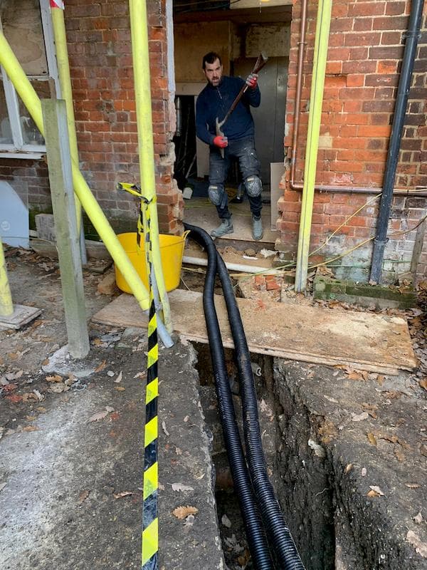 Temporary door created in the kitchen with one of the team playing a spade as a guitae