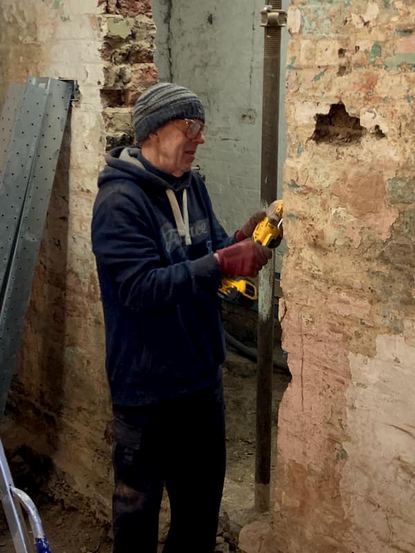 Steve with a smaller grider finishing off a wall ready for a new door frame to go in