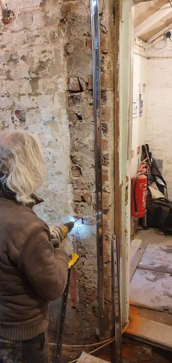 Tony drilling holes although it looks like a laser rather than a drill