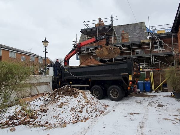 Debris being lifted into the tipper truck