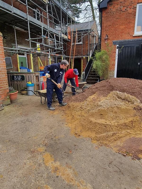 Loading a barrow with screed for the floor levelling