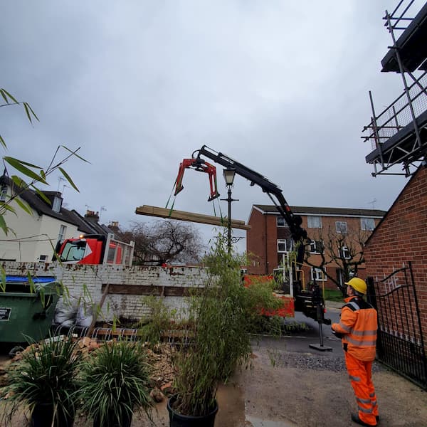 The onboard crane lifting wood into The Courtyard