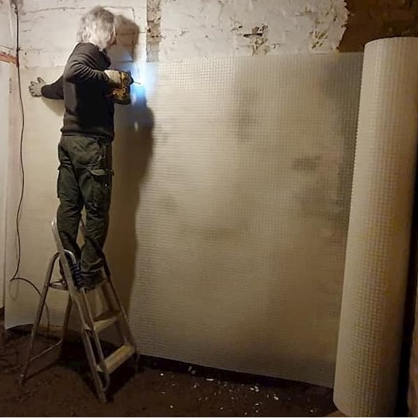 Tony putting up damp proof membrane