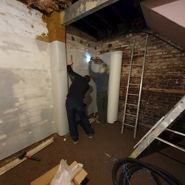 Team putting up membrane in The Storeroom