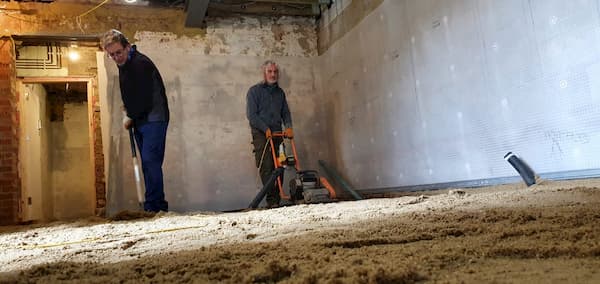 Tony and Trevor levelling and compacting the sand