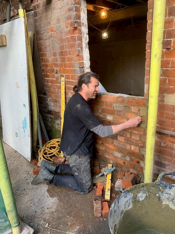 Bricking up the kitchen ourter wall where a temporary door was inserted