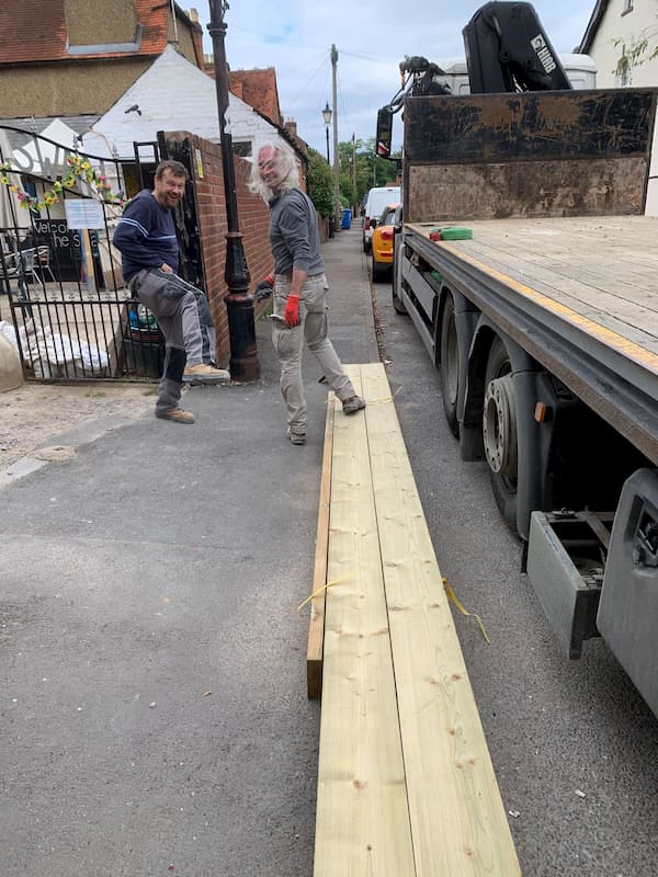 Tony and Ian receiving more building materials