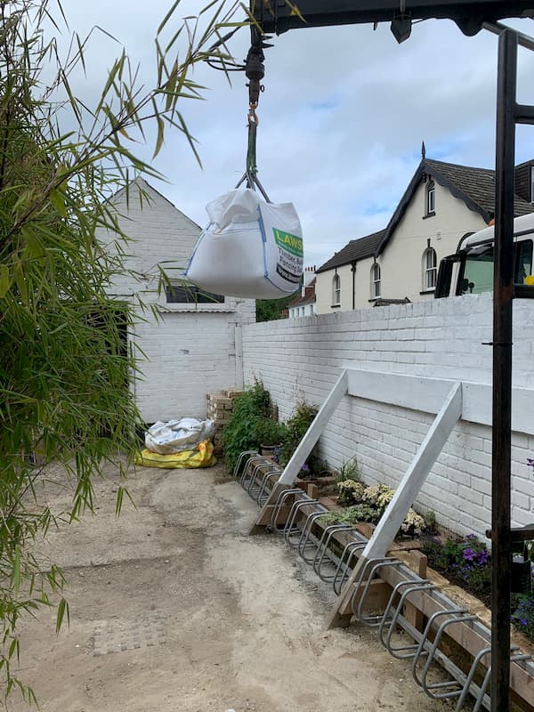 A one tonne bag of material being lowered into The Courtyard