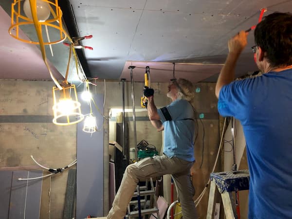 Trevor screwing in a ceiling board