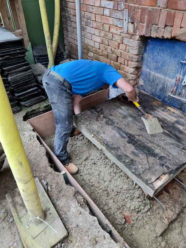 Making sure that the concrete is tapped down to get rid of any air