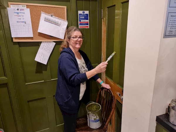 Rachel painting the cellar door