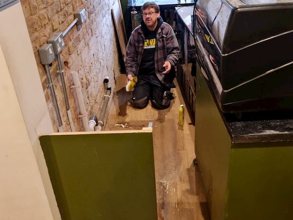 Ian cleaning the floor where the fridges have been